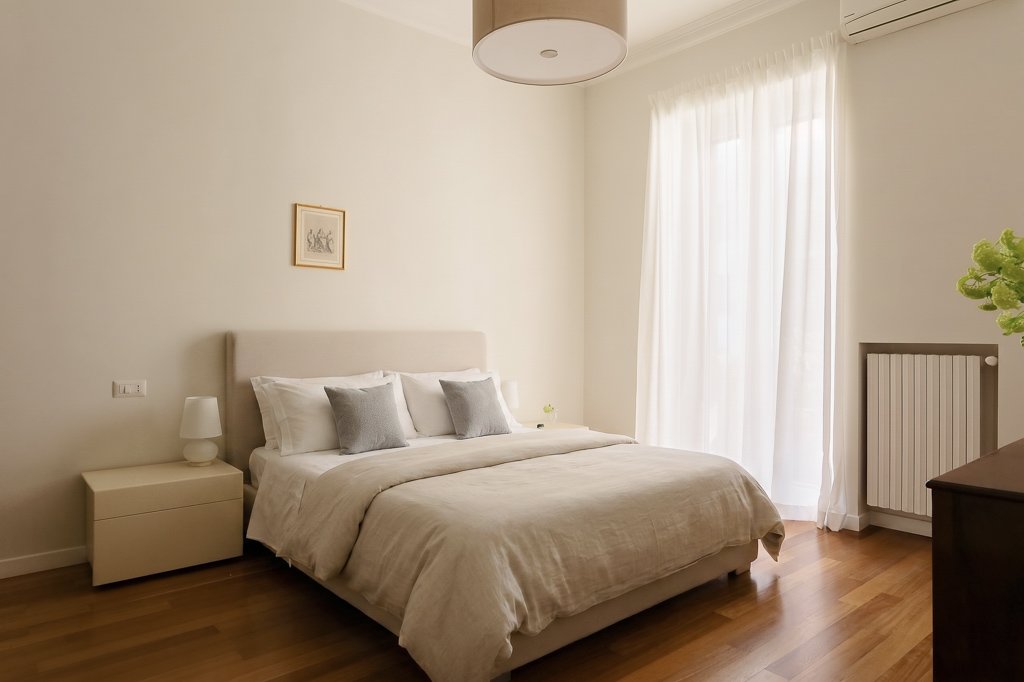 Same bedroom 1 after — clean styled bed, consistent look